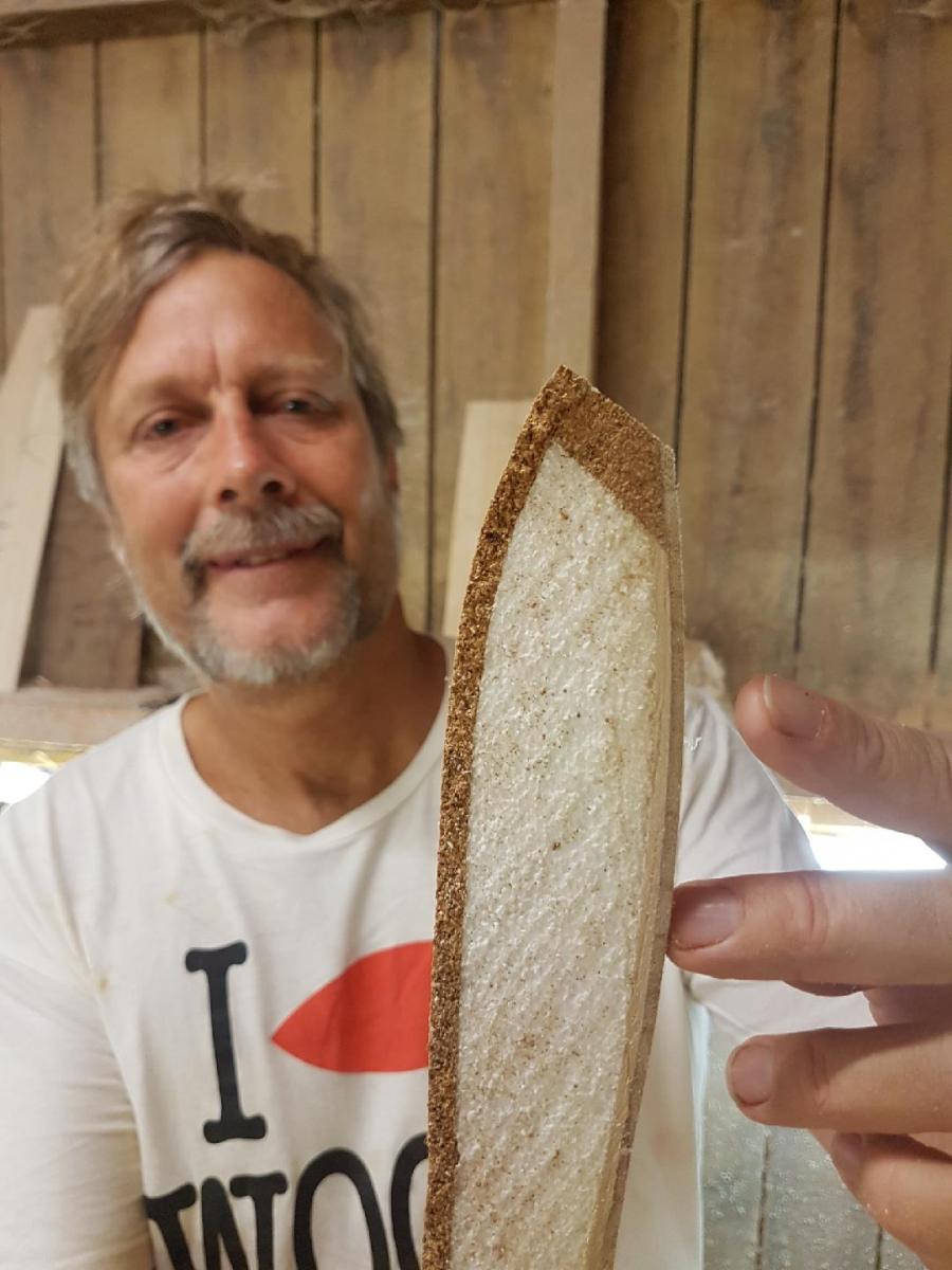 A cross section of a corky finless board. Made for flex and spring this board has Cork on top and rails, foam in the middle and two layers of paulownia on the bottom.